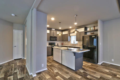 A kitchen with hardwood floors and stainless steel appliances.